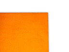 A close-up of a bright orange textured fabric or material corner against a plain white background.